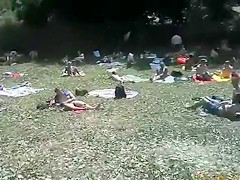 Nudist camp at the lake with lots of men and women