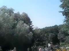 Nudist camp at the lake with lots of men and women