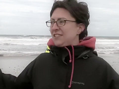 Hundreds of nudist people running into the sea naked