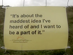 Hundreds of nudist people running into the sea naked