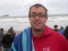 Hundreds of nudist people running into the sea naked