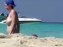 Pregnant cutie exposes her huge tits at the beach