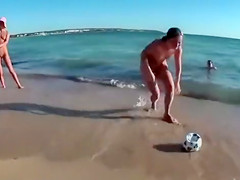 Four playful chicks and one ball