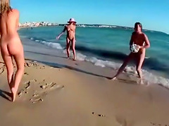 Four playful chicks and one ball