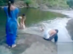 Naked Indian amateur teen swims in the river