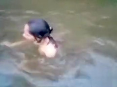 Naked Indian amateur teen swims in the river