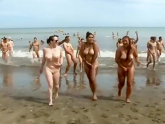 Huge group of nudists swim in the ocean