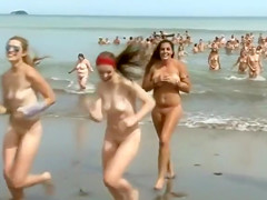 Huge group of nudists swim in the ocean
