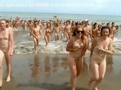 Huge group of nudists swim in the ocean