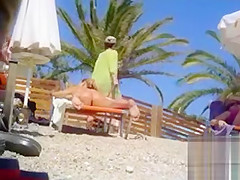 Tanned blonde takes off her bikini after a swim