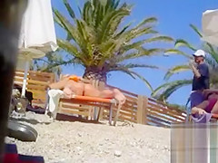 Tanned blonde takes off her bikini after a swim