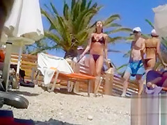 Tanned blonde takes off her bikini after a swim