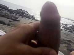 Stroking cock to a thick woman at the beach