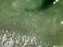 Nude couple hangs out on a sunny beach day