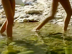 Nude teen beauties splash in the river