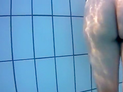 Underwater view with skinny dipping nudist women and men