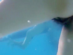 Underwater view with skinny dipping nudist women and men