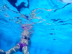 Underwater view with skinny dipping nudist women and men