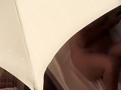 Curvy woman with a hairy labia relaxes under an umbrella