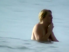Milf with saggy tits goes skinny dipping in the ocean