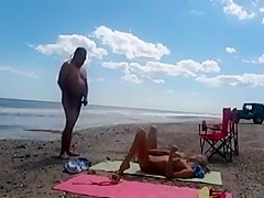 Nudist wife jerks off strangers at the beach and they cum on her