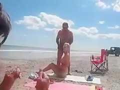 Nudist wife jerks off strangers at the beach and they cum on her
