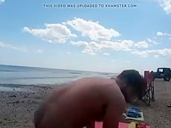 Nudist wife jerks off strangers at the beach and they cum on her