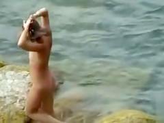 Nudist family alone on the beach relaxes all day