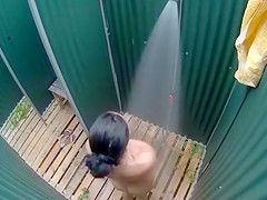 Dark haired bombshell takes a cold shower