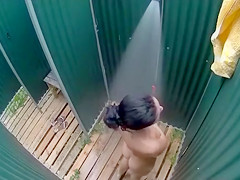 Dark haired bombshell takes a cold shower