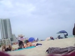 Naked black and white women filmed at the beach