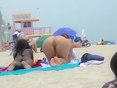 Naked black and white women filmed at the beach