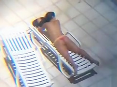 Long zoom on her tanned pair of buttocks