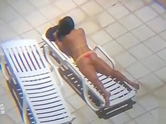 Long zoom on her tanned pair of buttocks