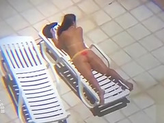 Long zoom on her tanned pair of buttocks