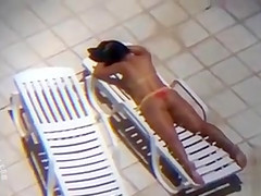Long zoom on her tanned pair of buttocks