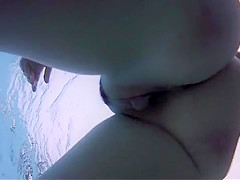 Naked women underwater at a nudist resort pool