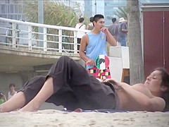 Milf with amazing tits filmed topless at the beach