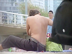 Milf with amazing tits filmed topless at the beach