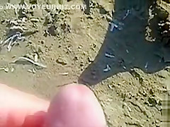 Cumshot on the ass of a girlfriend at the beach