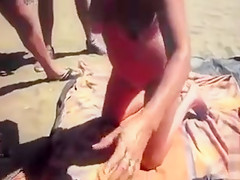 Slutty wife sucking and wanking dicks at the beach