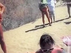 Slutty wife sucking and wanking dicks at the beach