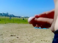 Ejaculating on a topless woman on the beach