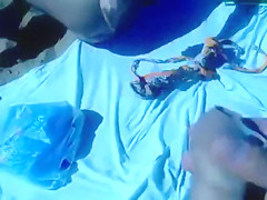 Ejaculating on a topless woman on the beach