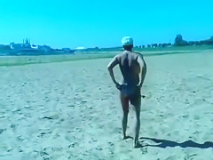Ejaculating on a topless woman on the beach