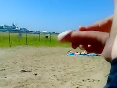 Ejaculating on a topless woman on the beach