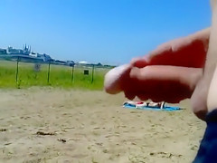 Ejaculating on a topless woman on the beach