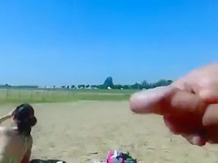 Ejaculating on a topless woman on the beach