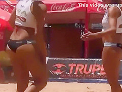 Beach volleyball girls with athletic asses in bikini bottoms