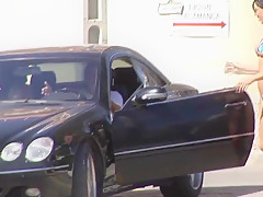 Hot brunette milf in micro bikini posing on public beach 1